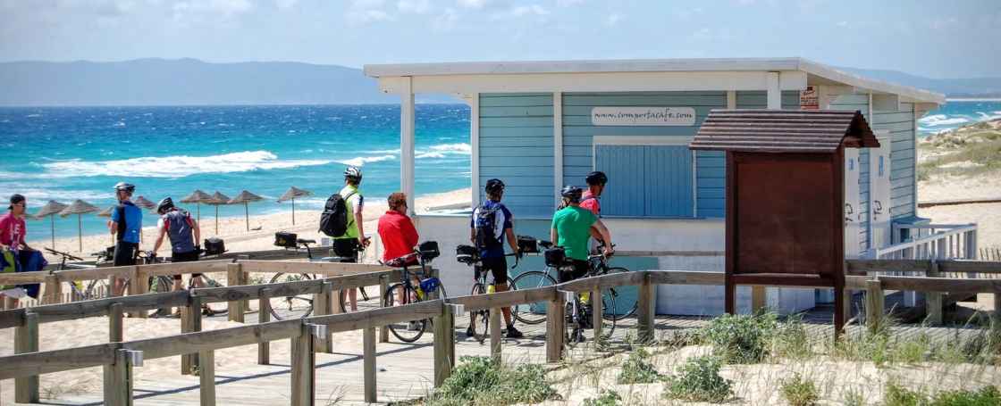Group of cyclists at a seafront bar on a Beginner bike tour