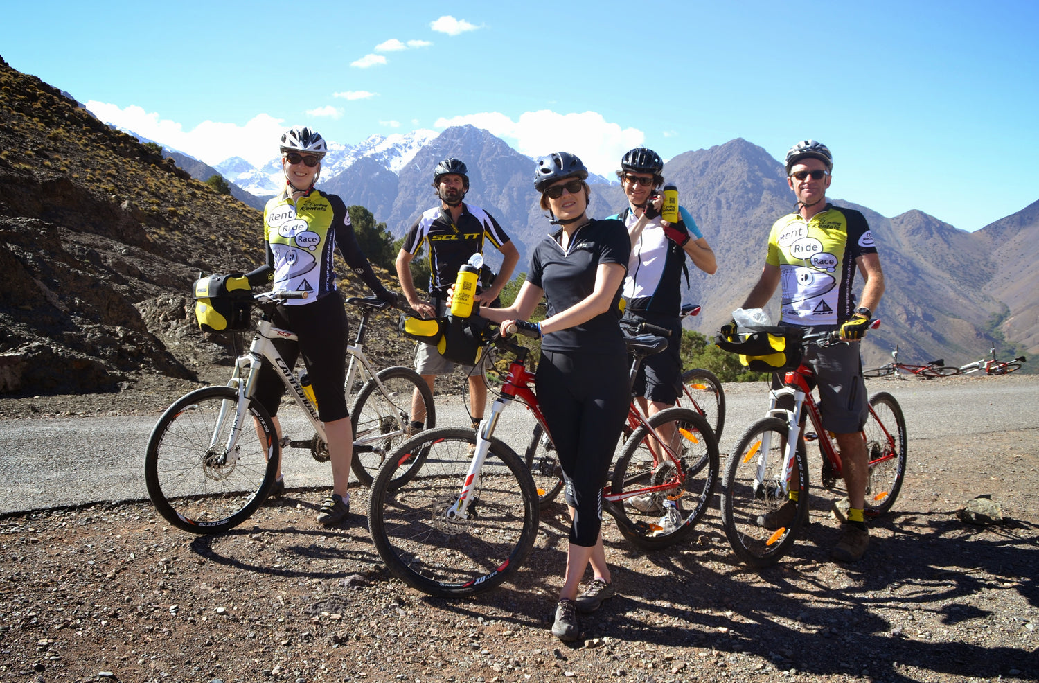 Group of cyclists with their bicycles in a mountainous area