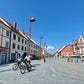 Couple cycling through a pretty town center on a bike tour in Slovenia